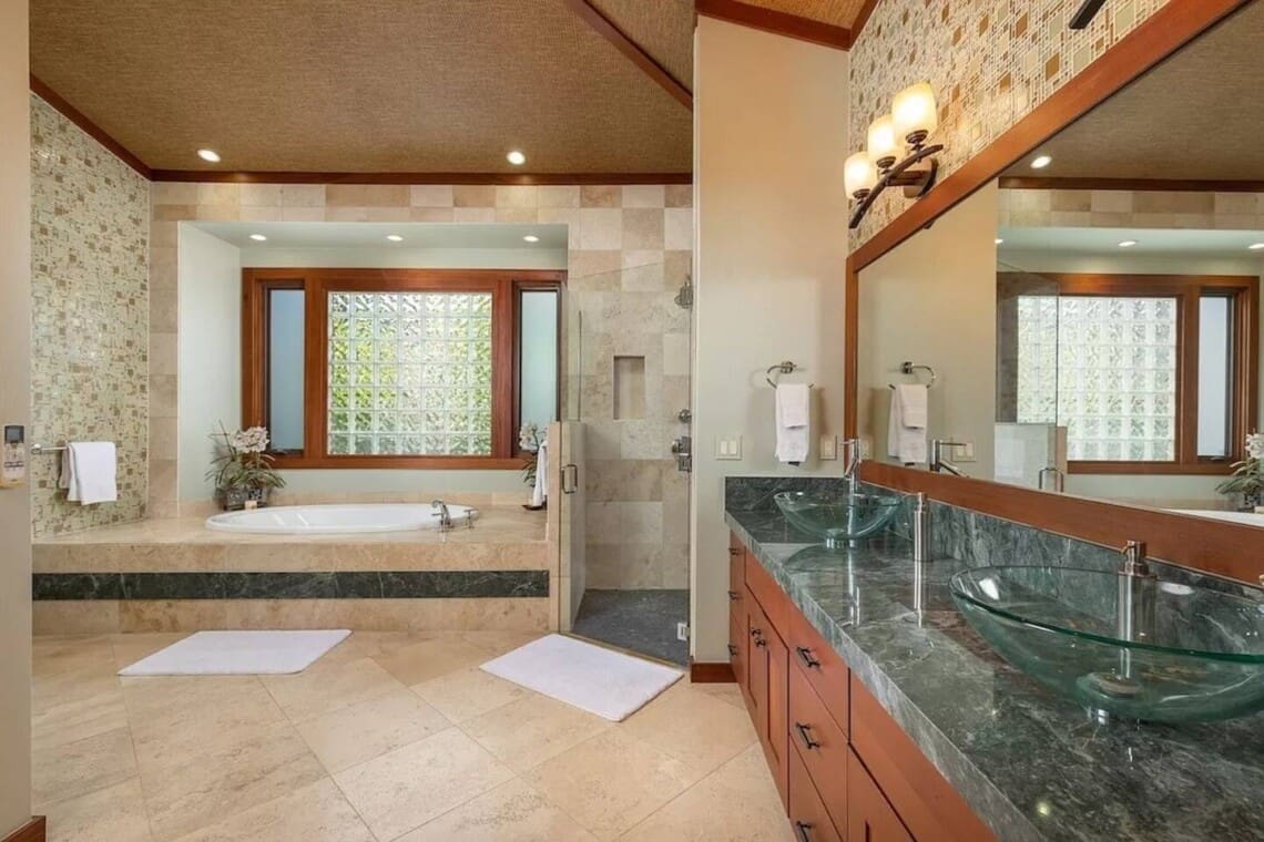 Spacious primary bathroom at Hale Mele featuring a double vanity, soaking tub, and walk-in shower in Mauna Lani, Hawaiʻi.