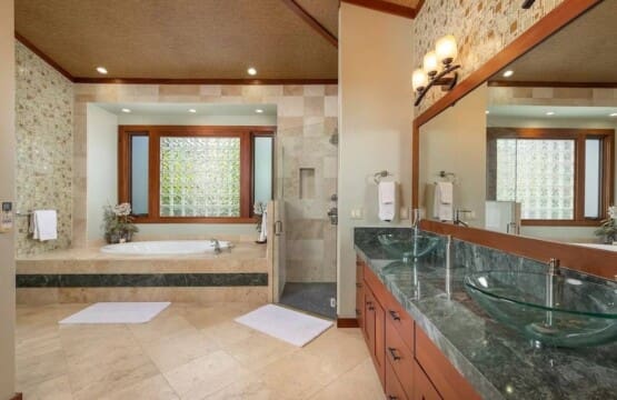 Spacious primary bathroom at Hale Mele featuring a double vanity, soaking tub, and walk-in shower in Mauna Lani, Hawaiʻi.