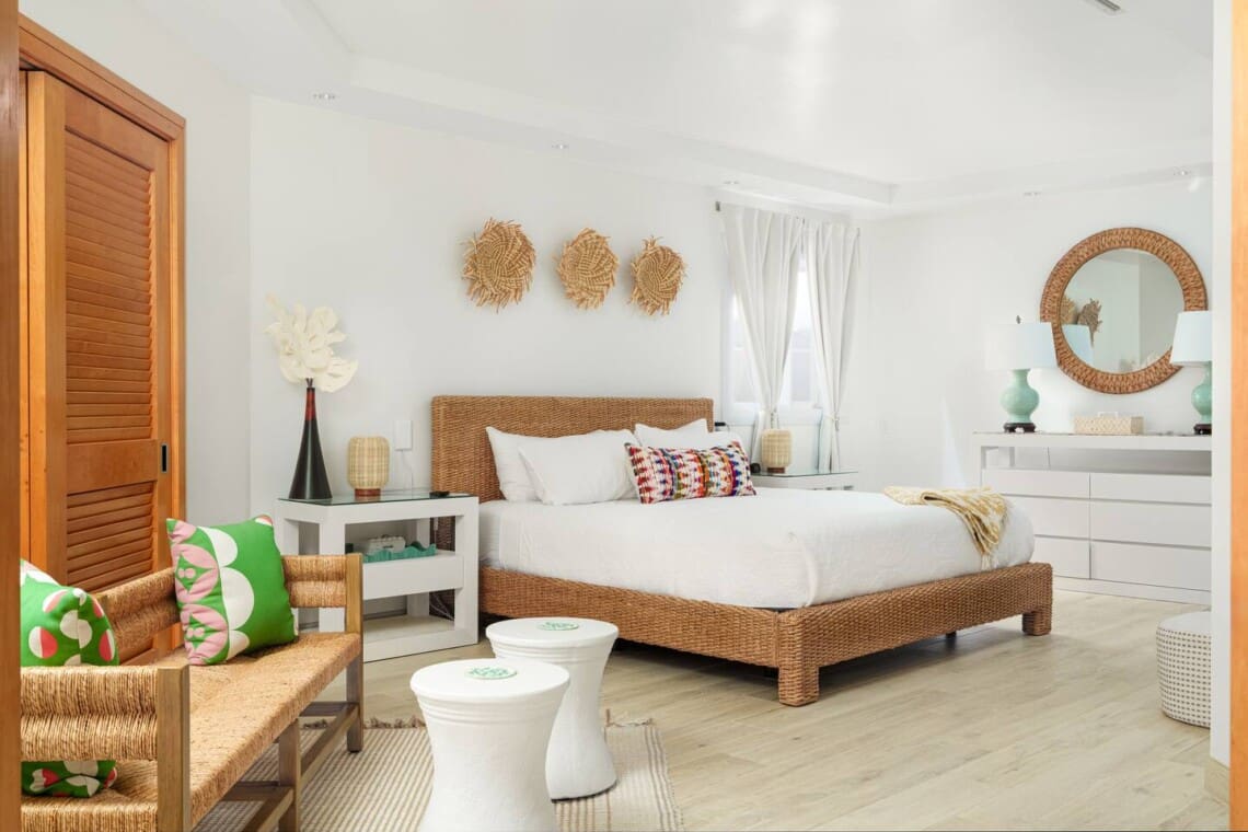 Spacious primary bedroom with king bed and tropical décor at Hale Mele luxury vacation rental in Mauna Lani