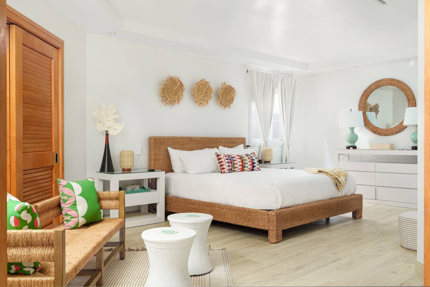 Spacious primary bedroom with king bed and tropical décor at Hale Mele luxury vacation rental in Mauna Lani