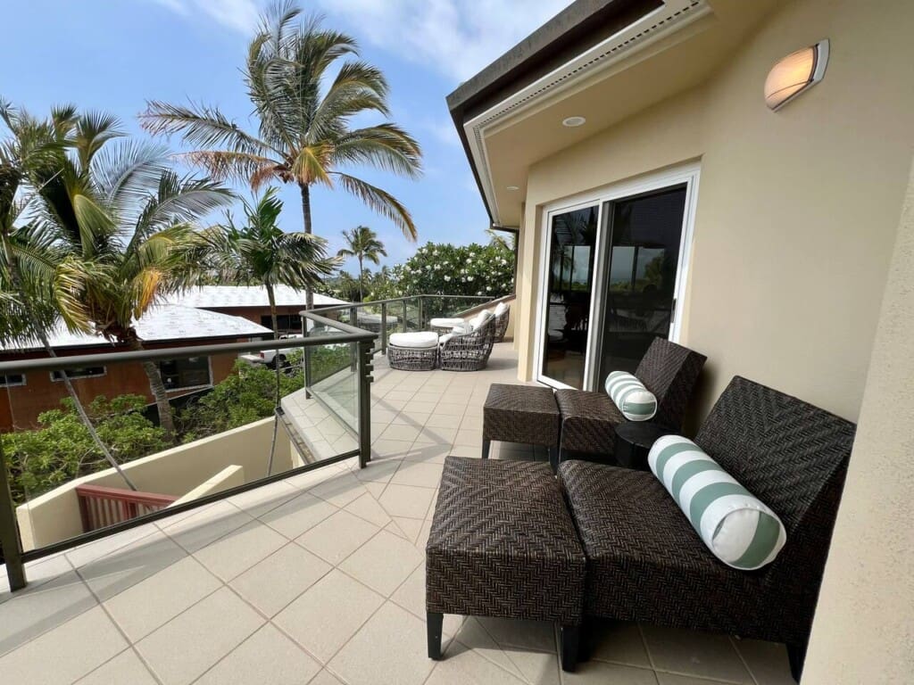 Private upper-level lanai with lounge seating at Hale Mele luxury vacation rental in Mauna Lani.