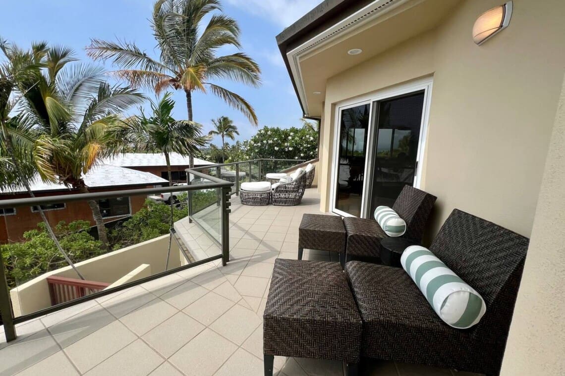 Private upper-level lanai with lounge seating at Hale Mele luxury vacation rental in Mauna Lani.