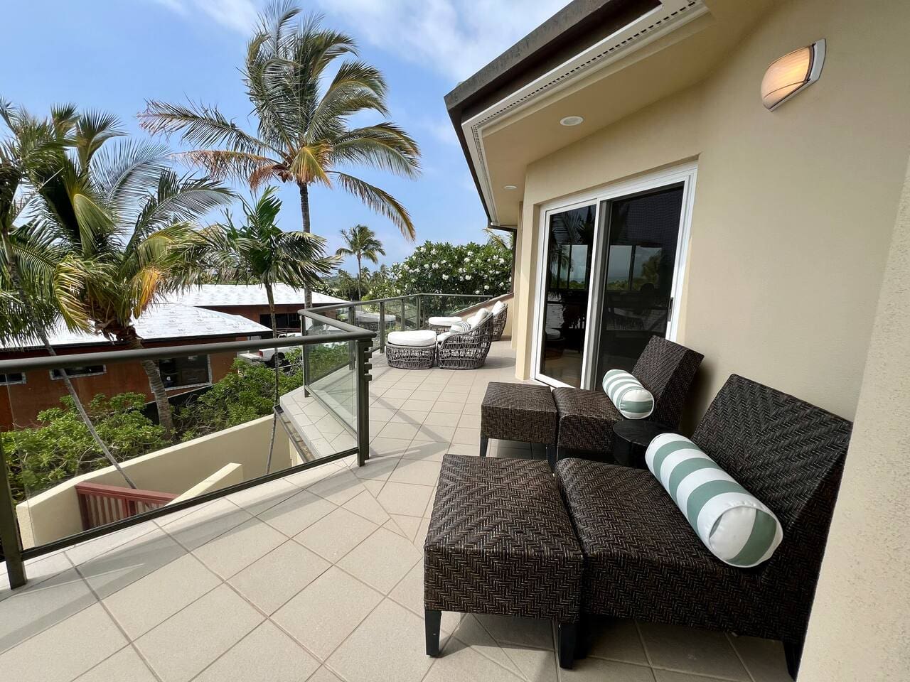 Private upper-level lanai with lounge seating at Hale Mele luxury vacation rental in Mauna Lani.