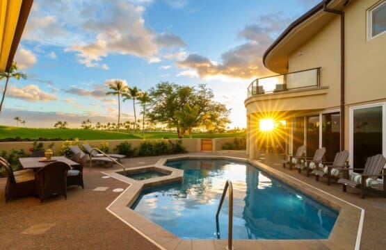 Private pool and spa with lounge chairs, outdoor dining area, and golf course views at sunset.