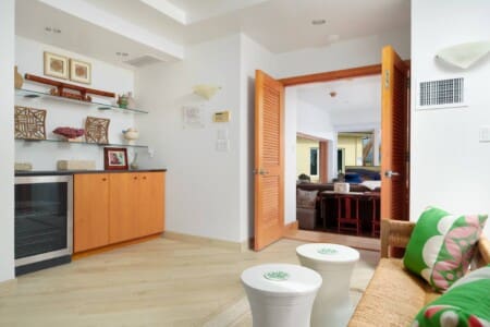Primary suite sitting area with refreshment center and mini fridge at Hale Mele luxury vacation rental in Mauna Lani.