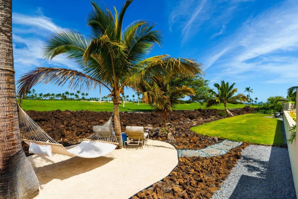 Hammock beneath palm trees overlooking the Mauna Lani golf course at Hale Mele on the Big Island of Hawaii