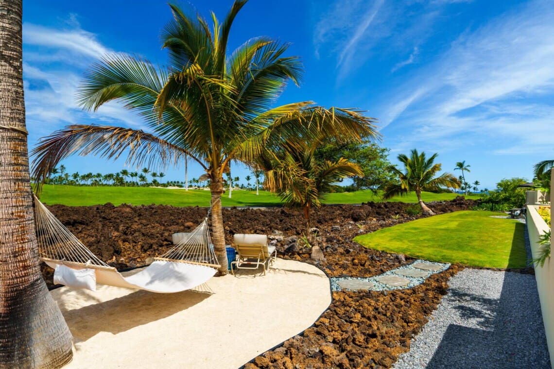 Hammock beneath palm trees overlooking the Mauna Lani golf course at Hale Mele on the Big Island of Hawaii