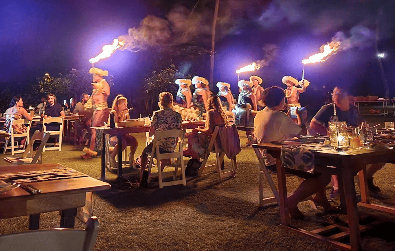 Guests watching a fire knife performance at the Hale Hoaloha Lūʻau at Mauna Lani on the Big Island of Hawaii